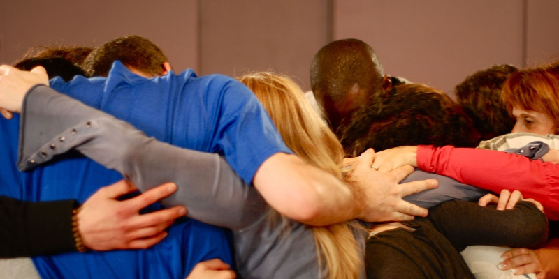 Actors in our Acting Classes Come Together, To Embrace In Ensemble after completing an intense group exercise 