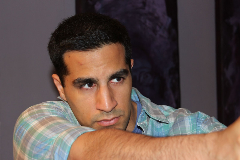 In this image, a beginner actor at our Toronto acting school works with embodiment while letting the face and eyes communicate organically for his film role