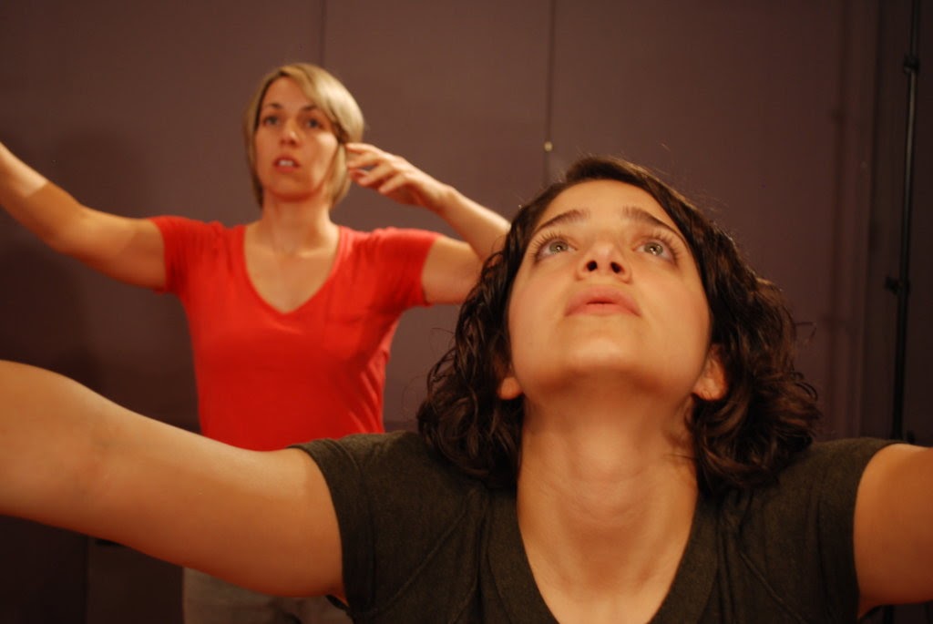 Two actors in our Toronto acting class practice a body breathing exercise to drop into the body